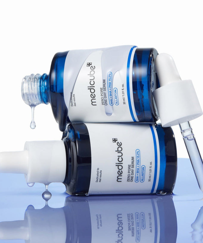 MEDICUBE Zero Pore One-Day Serum 30ml bottles on a reflective surface with open droppers.