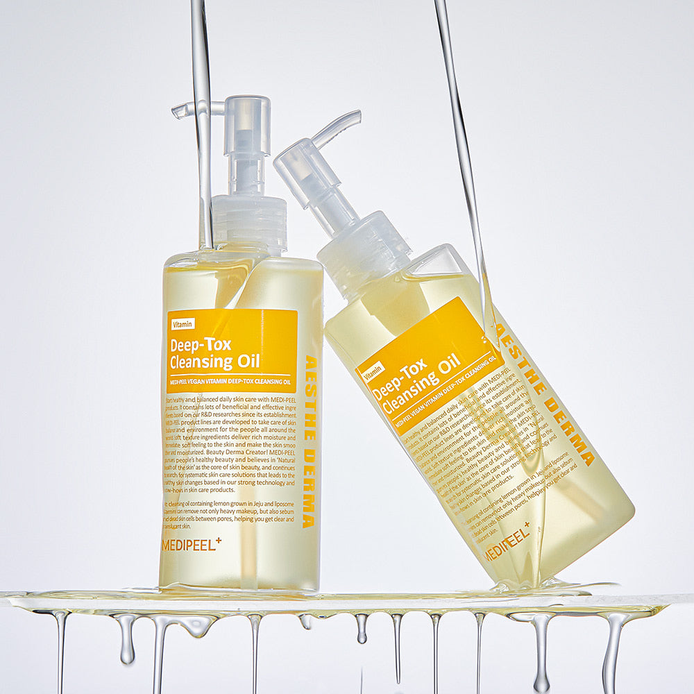 MEDIPEEL Vegan Vitamin Deep Tox Cleansing Oil 200ml displayed with two bottles and oil dripping, highlighting skincare benefits.