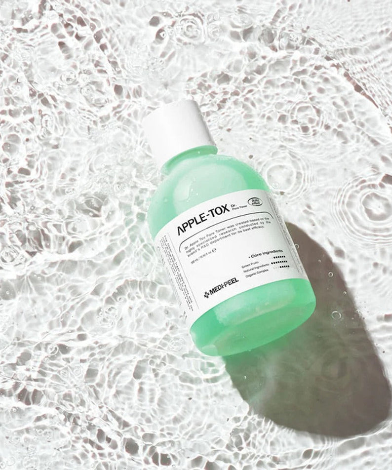 MEDIPEEL Dr.Apple Tox Pore Toner 500ml bottle on rippled water surface