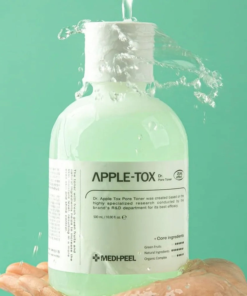 MEDIPEEL Dr.Apple Tox Pore Toner 500ml held in hand with water splashing