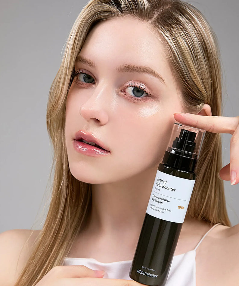 Woman holding a bottle of MEDITHERAPY Retinal Skin Booster Serum 150ml for skincare