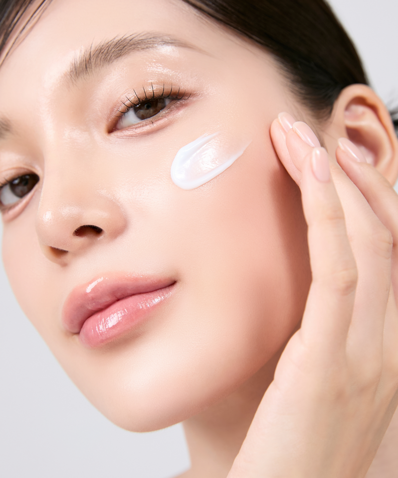 Woman applying MEDITHERAPY Squalane Skin Booster Moisturizer 150ml on cheek for radiant skin care