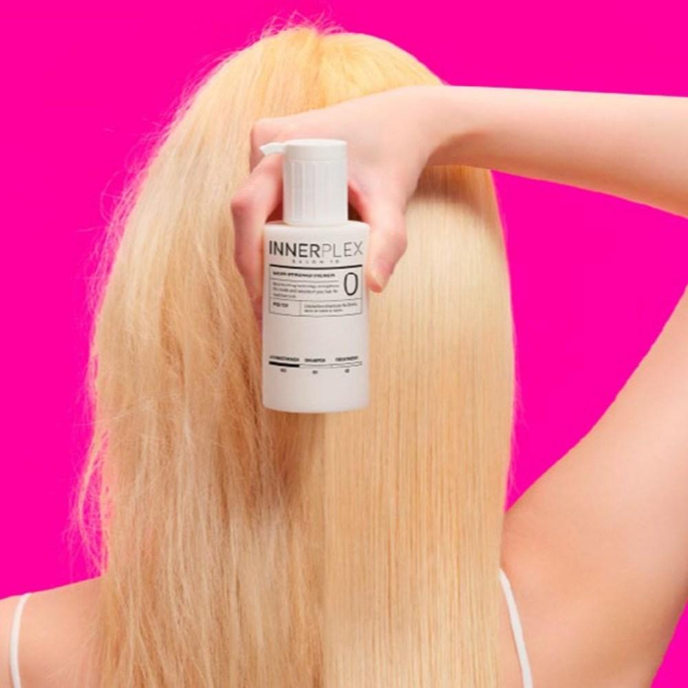Blonde hair with MISE EN SCENE Innerplex Hair Strengthener 145g Plan held against pink background