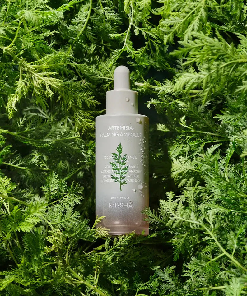 MISSHA Artemisia soothing ampoule 50ml bottle displayed on lush greenery background