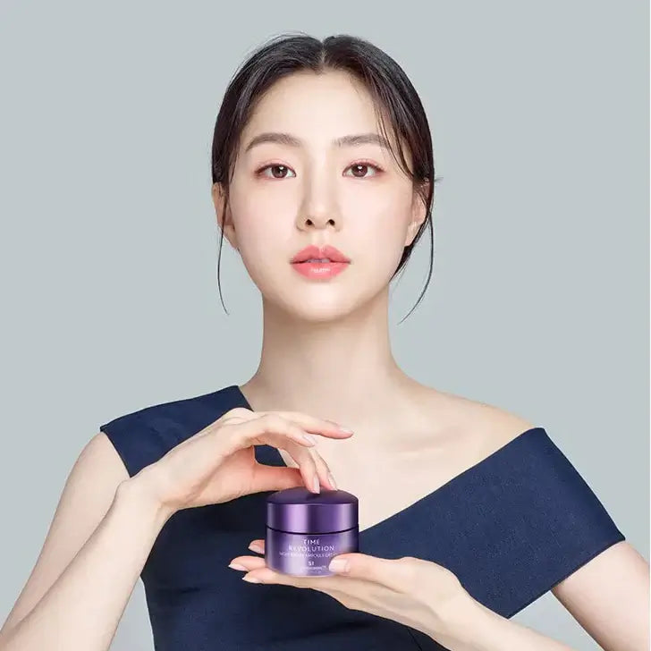 Woman holding MISSHA Time Revolution Night Repair Ampoule Cream 5X 50ml jar