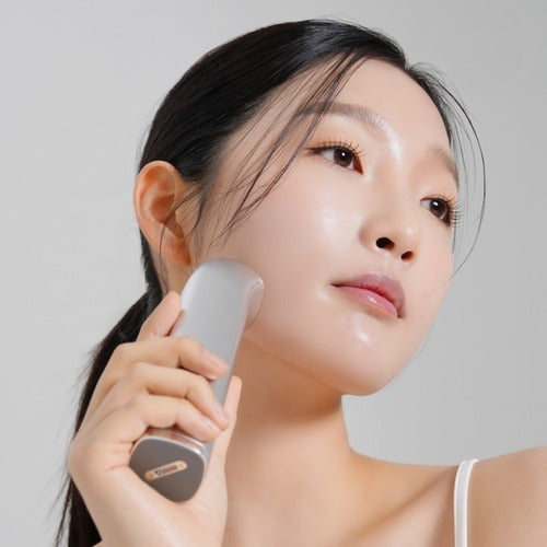 Woman using MIXSOON Derma Booster Pro on her face for skincare routine