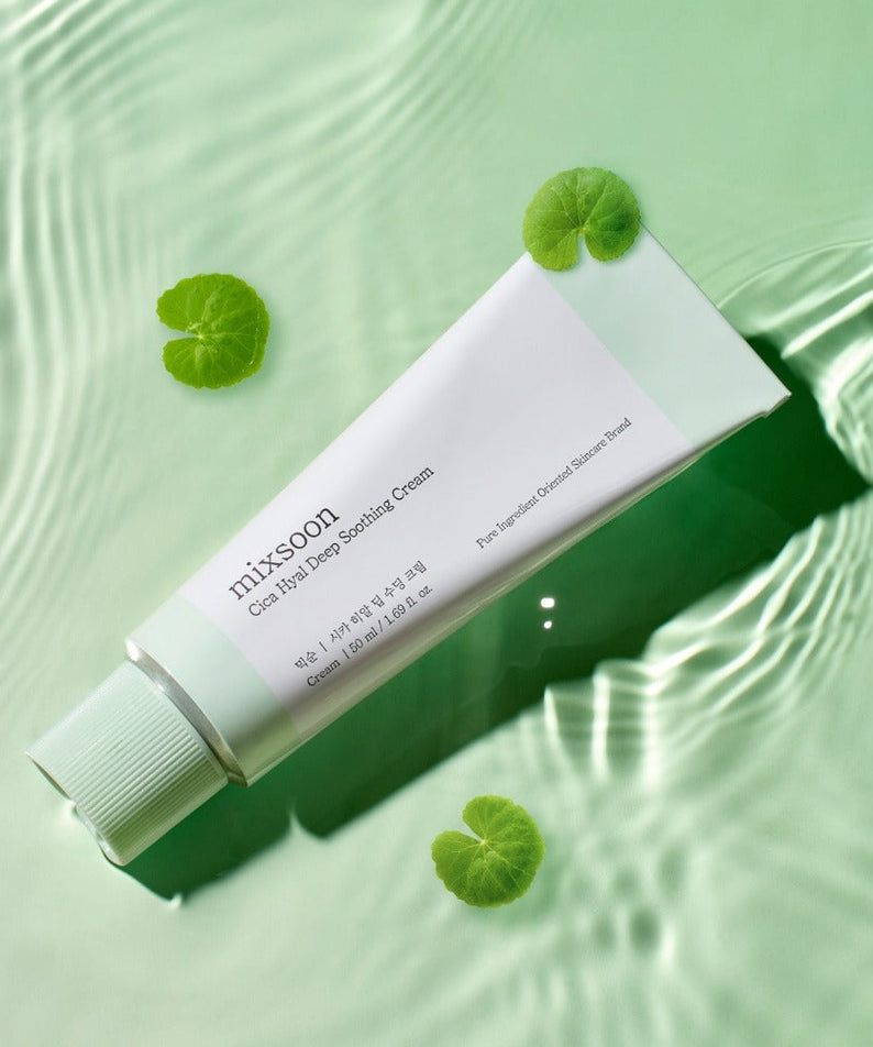 MIXSOON Cica Hyal Deep Soothing Cream 50ml tube on a reflective green background with leaves