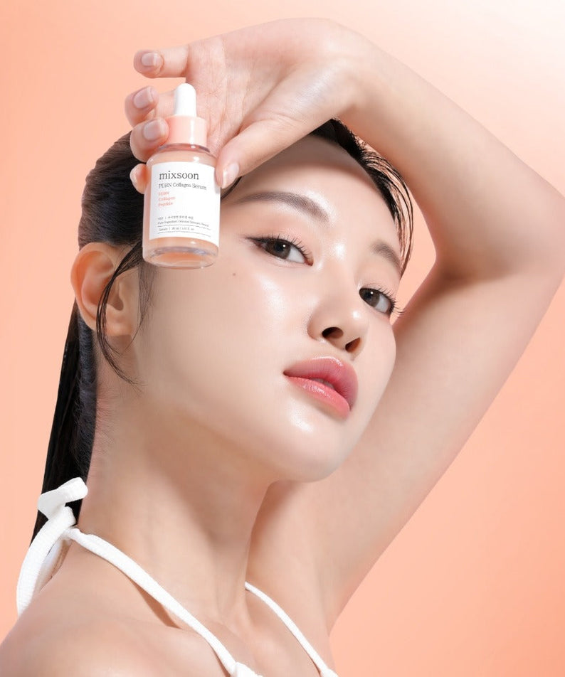 Woman holding bottle of MIXSOON PDRN Collagen Serum 30ml against an orange background