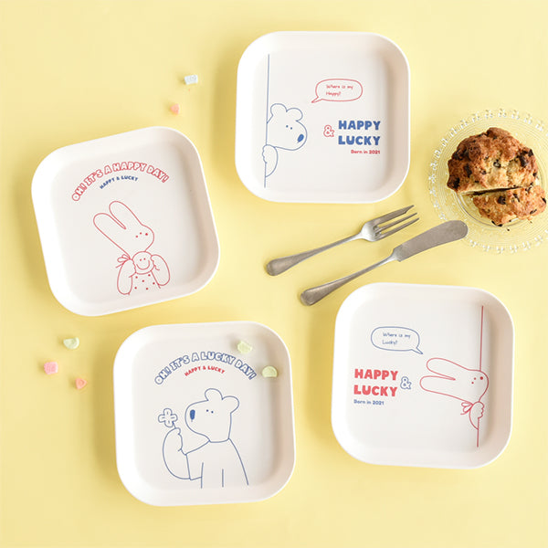 MONOLIKE Happy And Lucky Square Tray featuring cute animal designs on a yellow background with fork and pastry.