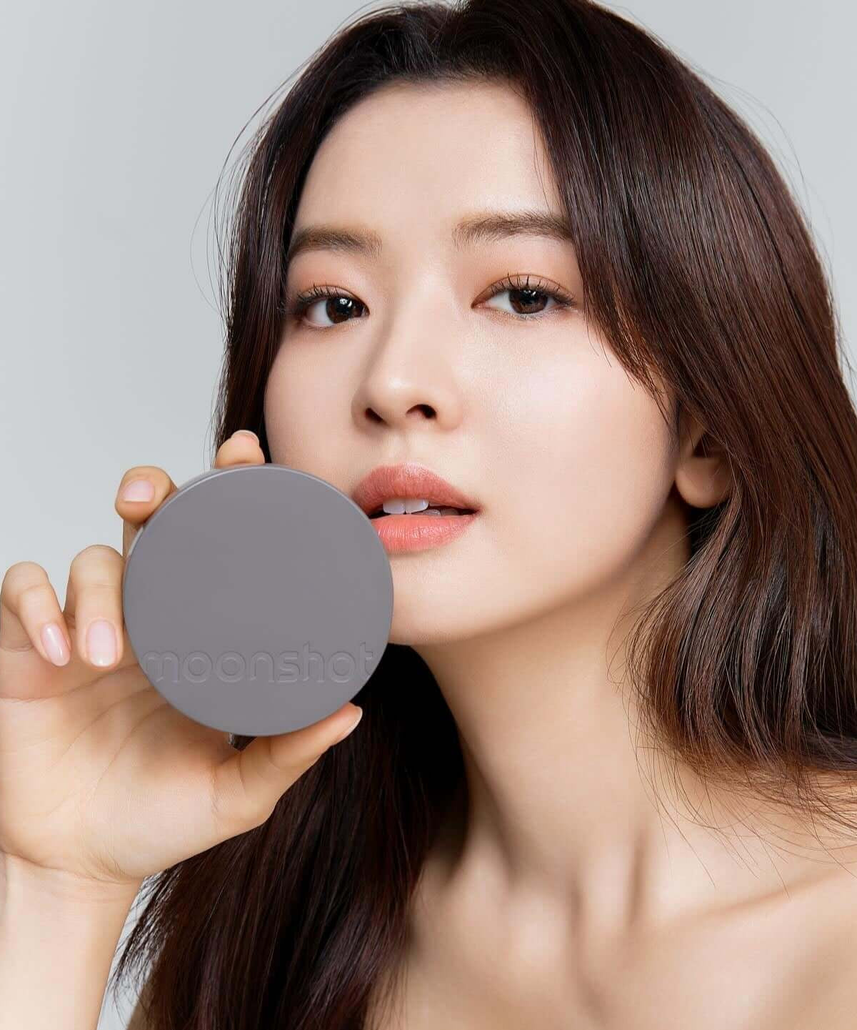 Woman holding MOONSHOT Conscious Fit Matte Cushion Foundation