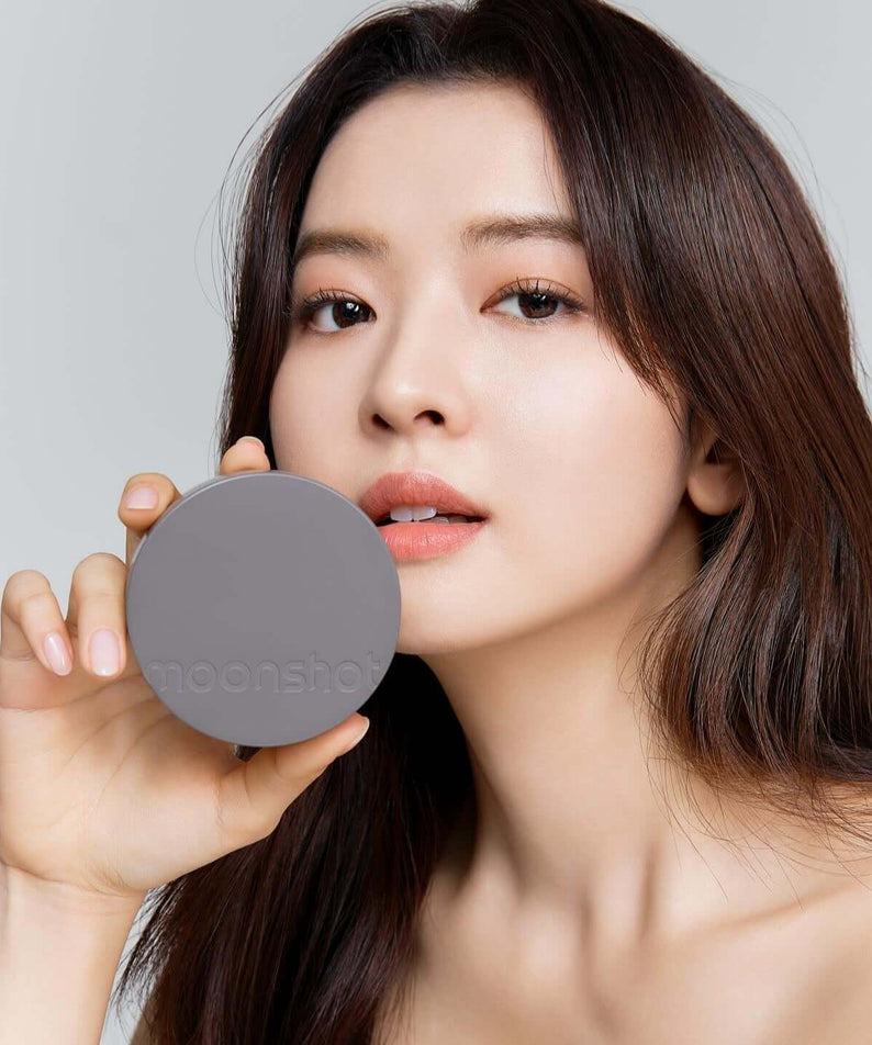 Woman holding MOONSHOT Conscious Fit Matte Cushion Foundation