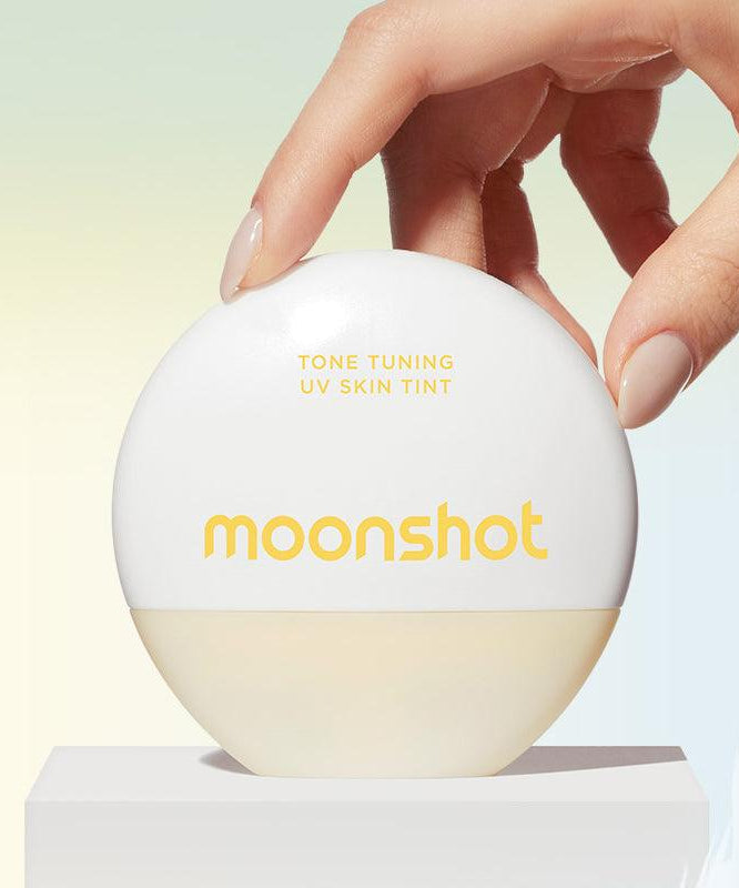 MOONSHOT Tone Tuning UV Skin Tint SPF50+ PA++++ product image with hand holding the round cream white container.