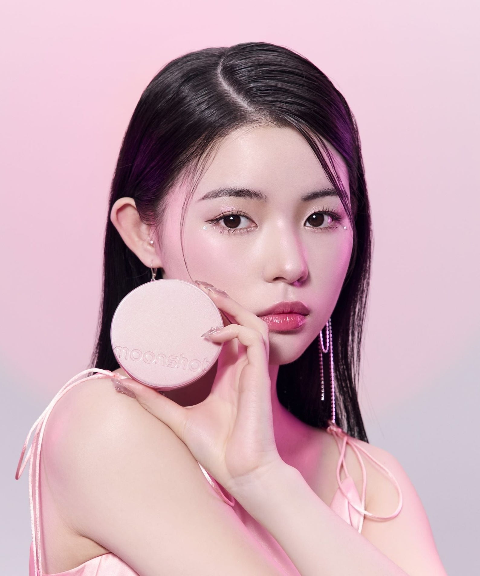 MOONSHOT Conscious Fit Cushion Foundation Pink Moon Edition showcased by a model in a pink-themed setting.