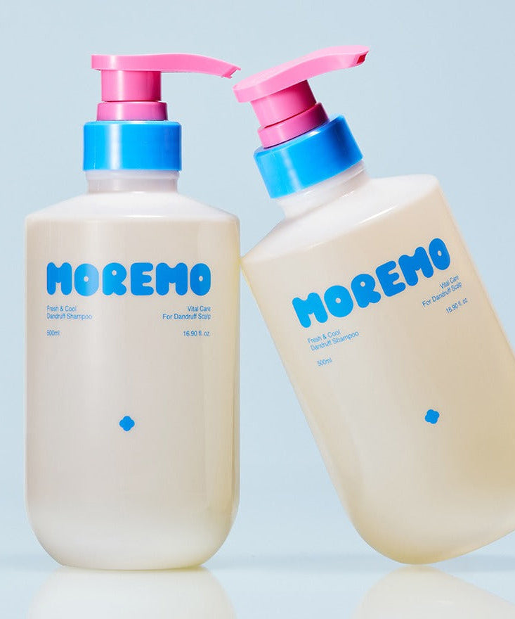 Photo of MOREMO Fresh & Cool Dandruff Shampoo 500ml bottles with pink and blue pump dispensers on a blue background.