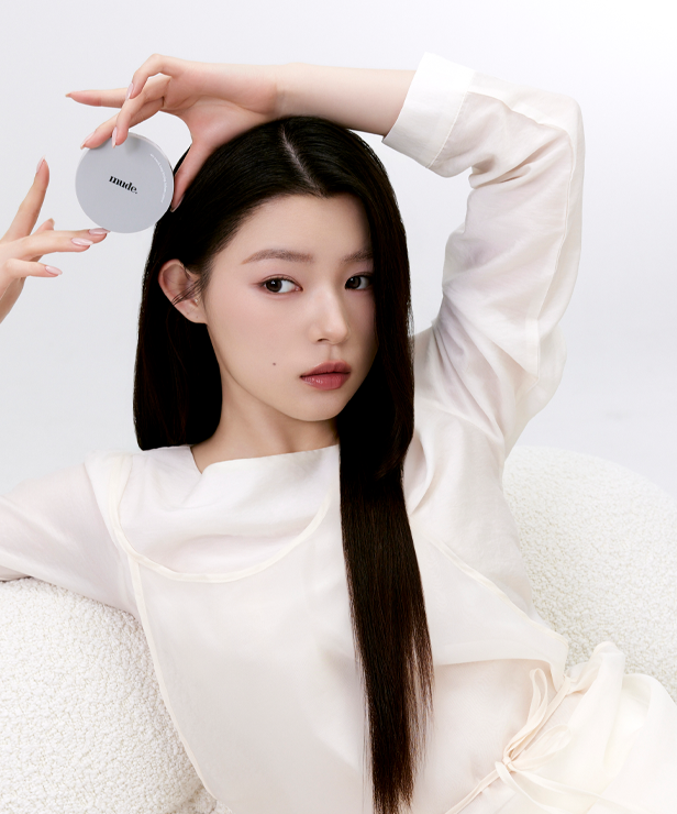 Woman holding MUDE Settingn Powder Patch in white attire