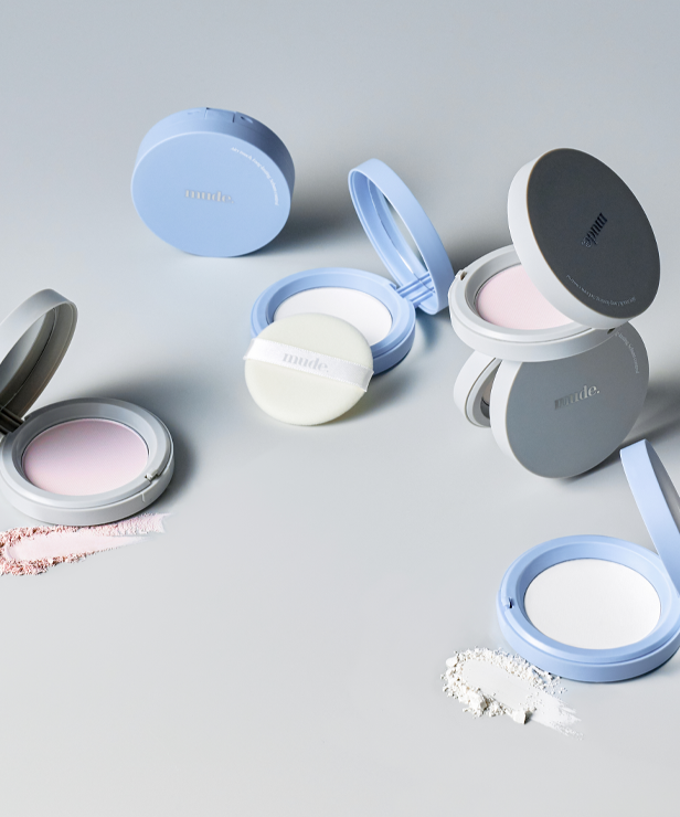 Assorted MUDE Settingn Powder Patch compacts displayed on a light surface.
