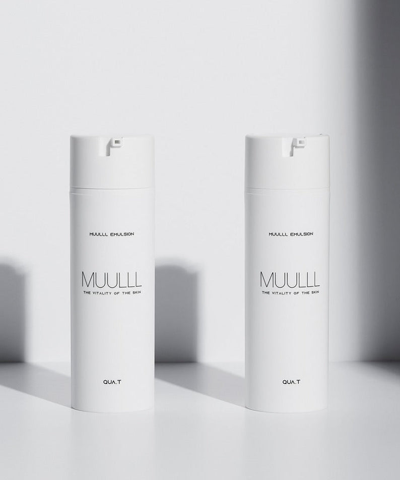 Two bottles of QUA-T Emulsion 150ml placed side by side in bright lighting against a white background.