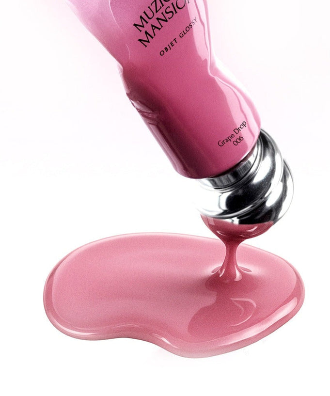 MUZIGAE MANSION Object Glossy pink tube pouring glossy liquid on surface