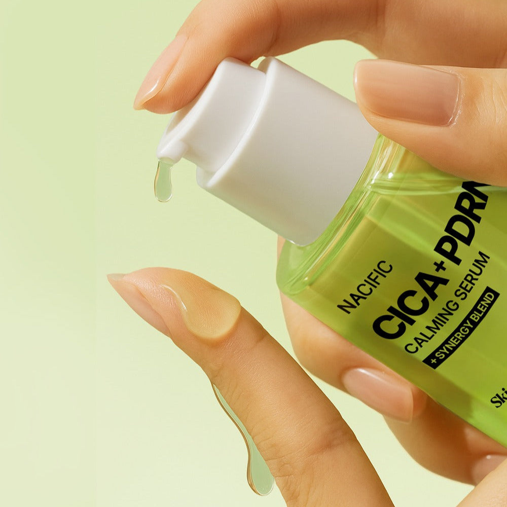 Close-up of NACIFIC Fresh Cica PDRN Calming Serum 50ml being dispensed onto fingers.