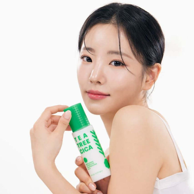 Woman holding NATURE REPUBLIC Green Derma Tea Tree Cica Clear Emulsion 130ml