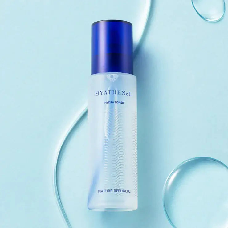 NATURE REPUBLIC Hyathenol Hydra Toner 150ml bottle on a light blue background with water droplets.