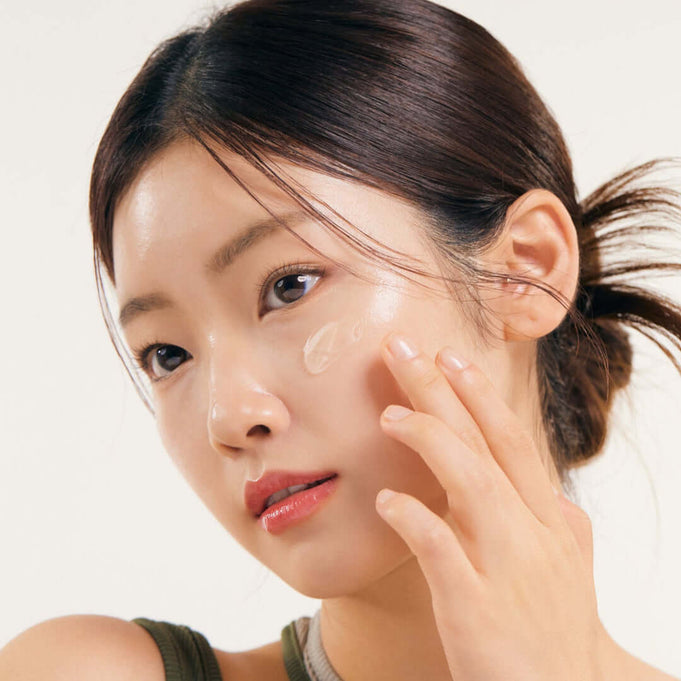 Model applying NATURE REPUBLIC Real Squeeze Aloe Vera Cream 55ml to her face for hydrated skin routine