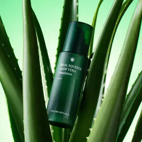 NATURE REPUBLIC Real Squeeze Aloe Vera Essence 50ml bottle surrounded by aloe leaves, vibrant green background