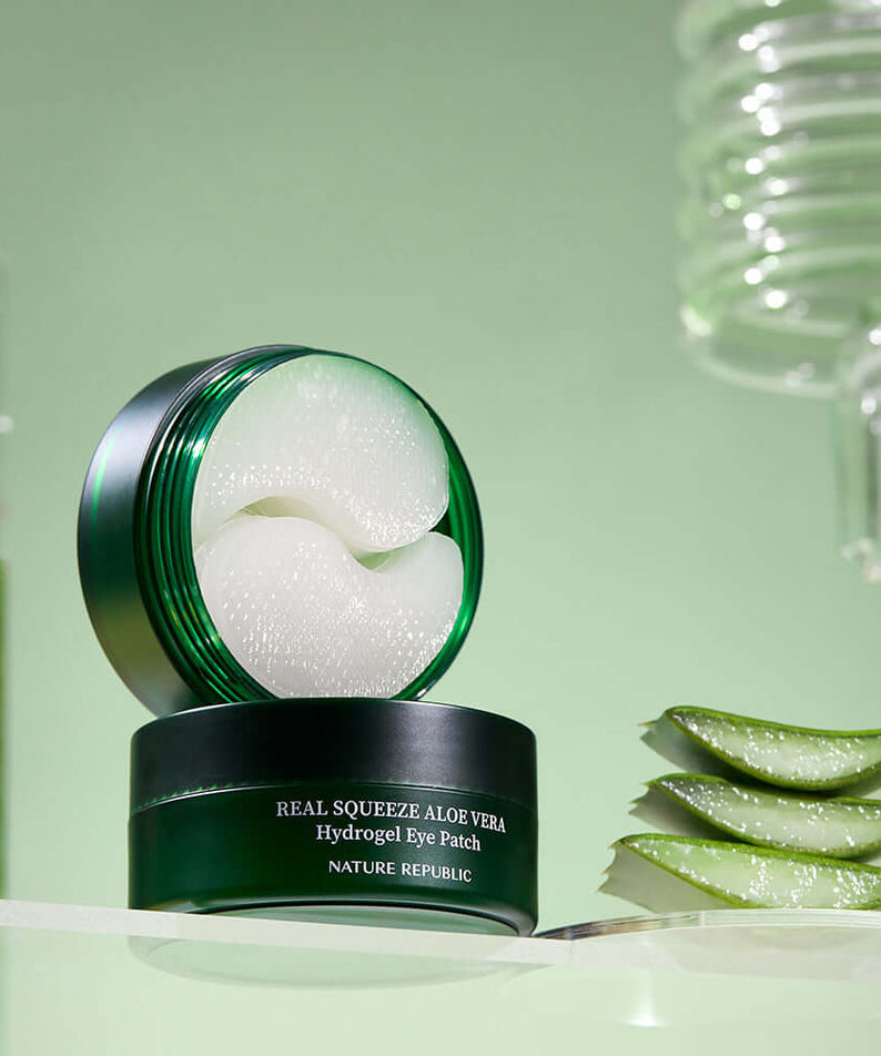 NATURE REPUBLIC Real Sueeze Aloe Vera Hydrogel Eye Patchh 60sheets product on display with aloe vera and green background