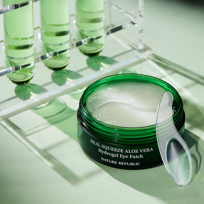 NATURE REPUBLIC Real Sueeze Aloe Vera Hydrogel Eye Patchh 60sheets with soothing formula in a green container.
