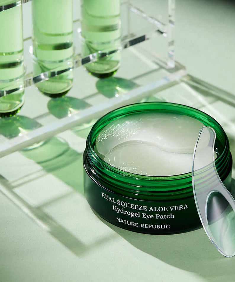 NATURE REPUBLIC Real Sueeze Aloe Vera Hydrogel Eye Patchh 60sheets with soothing formula in a green container.