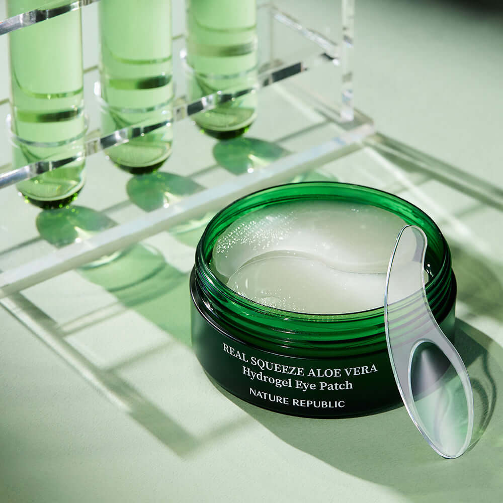 NATURE REPUBLIC Real Sueeze Aloe Vera Hydrogel Eye Patchh 60sheets with soothing formula in a green container.