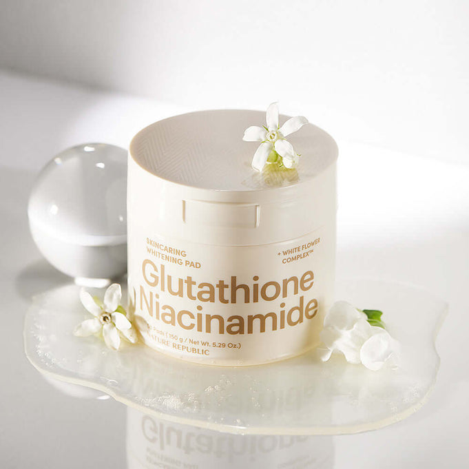 NATURE REPUBLIC Skincaring Whitening Pads 150g displayed with flowers on a white surface, highlighting Glutathione and Niacinamide ingredients.