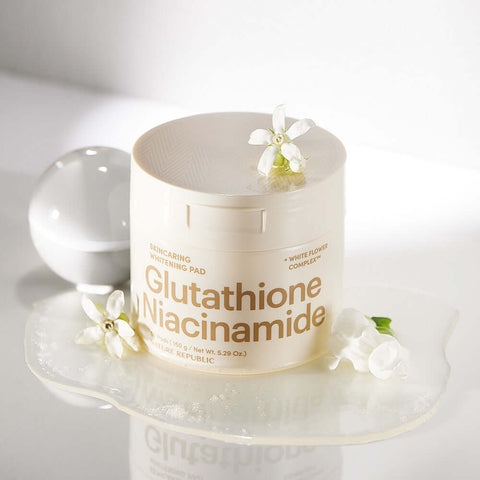 NATURE REPUBLIC Skincaring Whitening Pads 150g displayed with flowers on a white surface, highlighting Glutathione and Niacinamide ingredients.