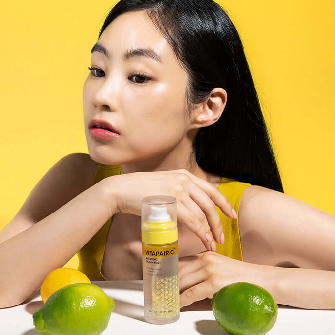 Woman with NATURE REPUBLIC Vitapair C Blending Serum Mist 80ml and citrus fruits