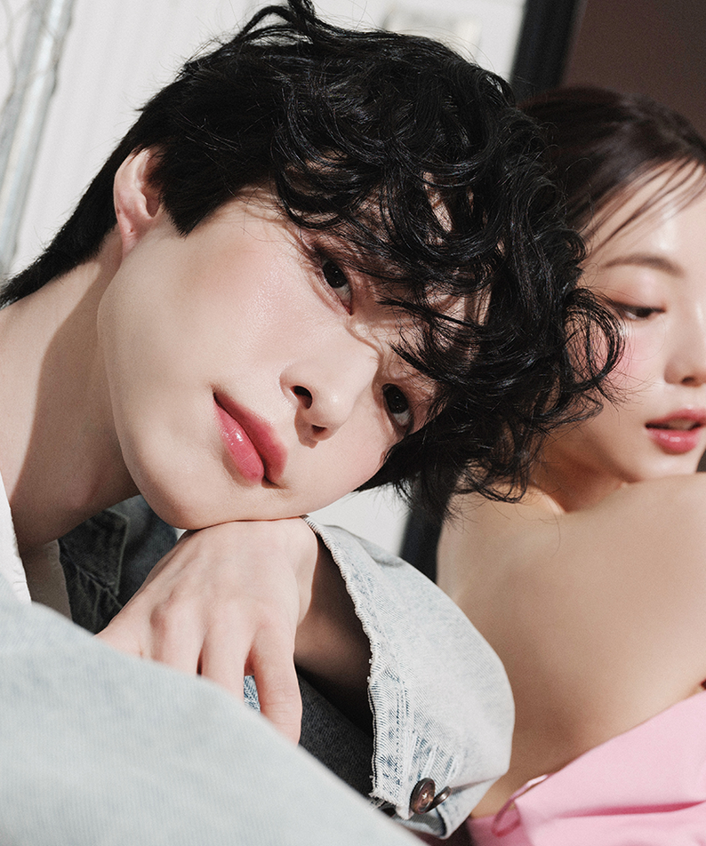 Two models showcasing radiant skin and style, ideal promotion for QUA-T The Glass Tattoo Tint beauty product.