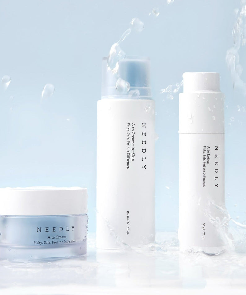 NEEDLY A to Cream Skin 150ml product packaging with water splash on a blue background, highlighting skincare qualities.