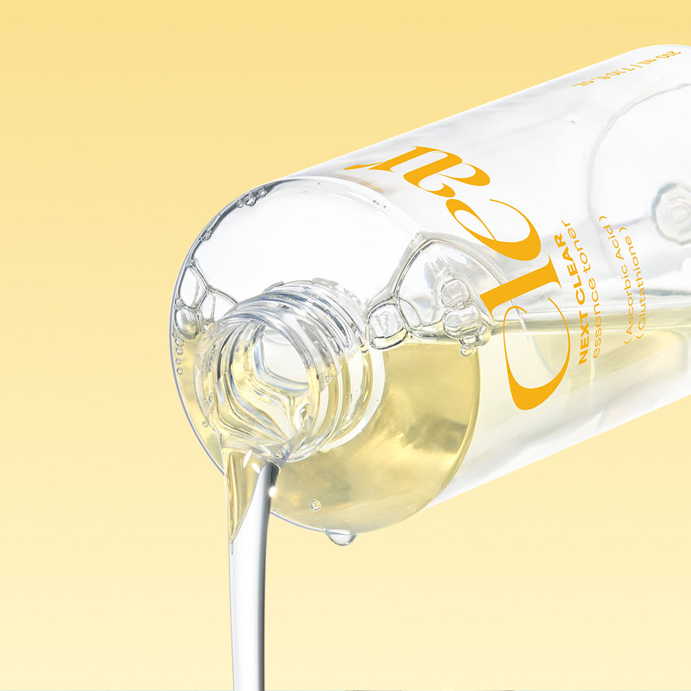 NEOGEN Next Clear Essence Toner 210ml bottle pouring liquid against yellow background
