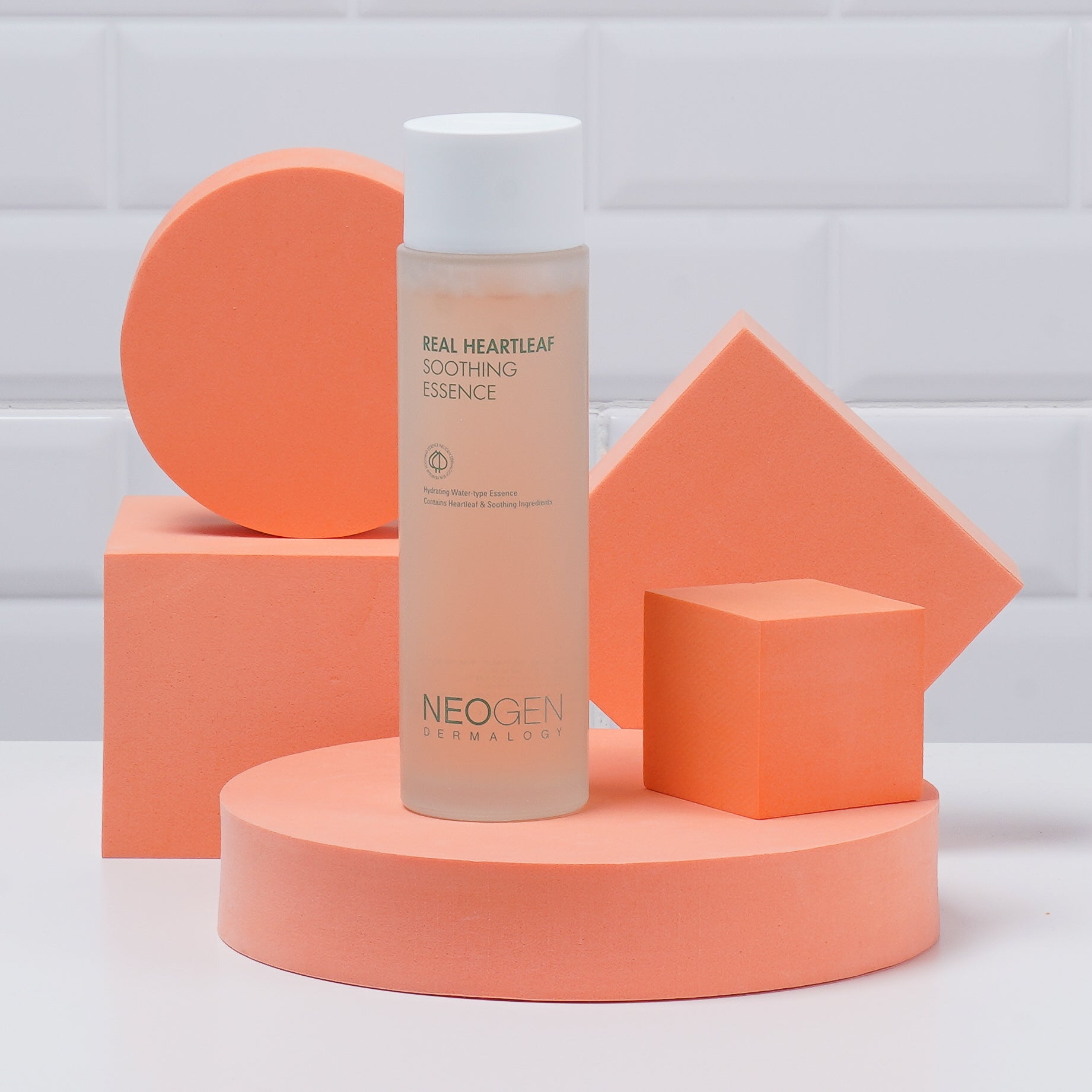 NEOGEN Real Heartleaf Soothing Essence 150ml bottle set against geometric shapes
