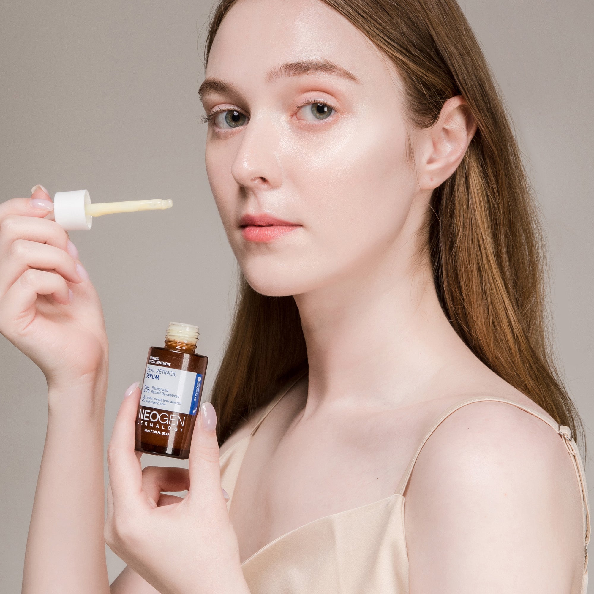 Woman applying NEOGEN Real Retinol Serum 30ml to her face