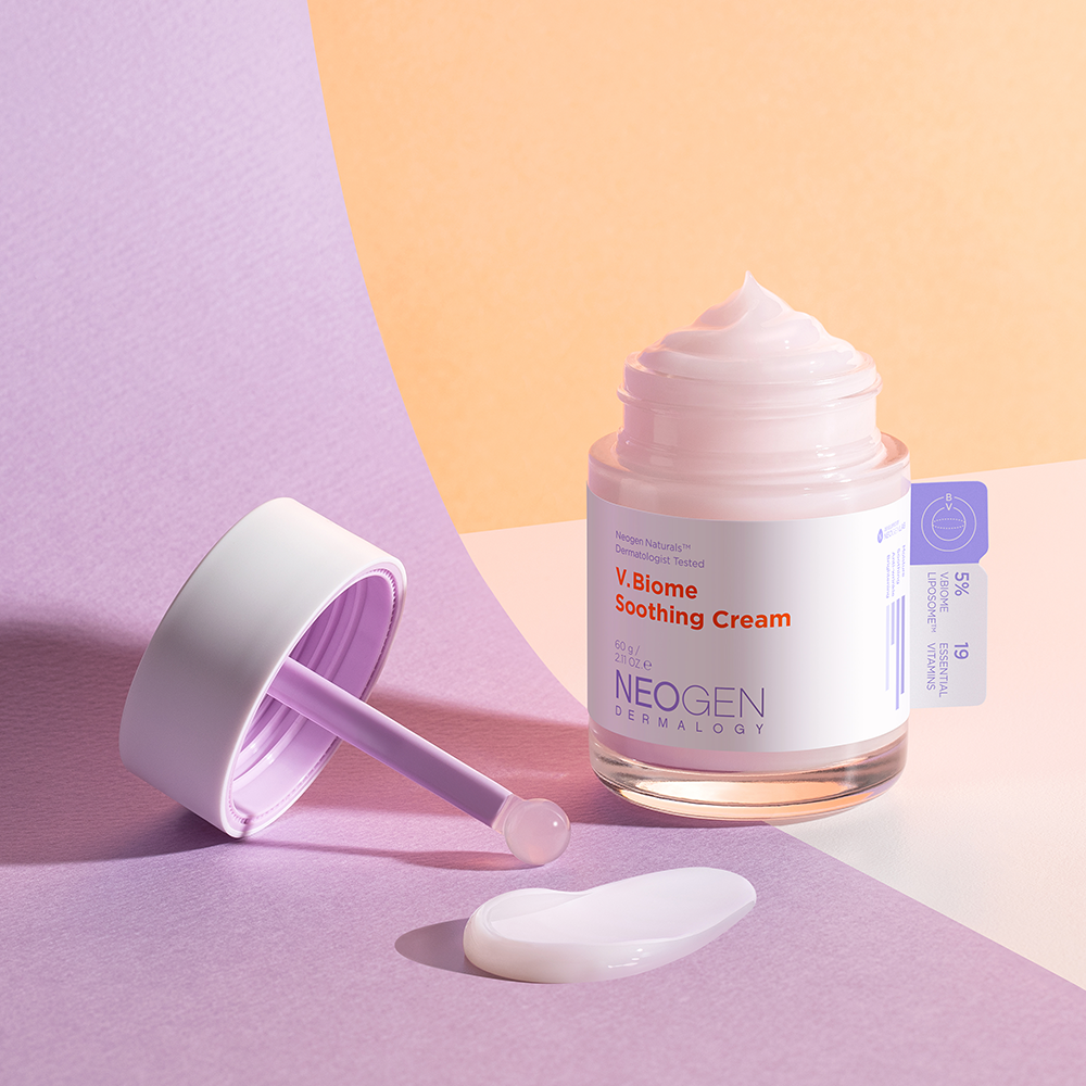 NEOGEN V Biome Soothing Cream 60g in open jar with purple scoop on a pastel background.