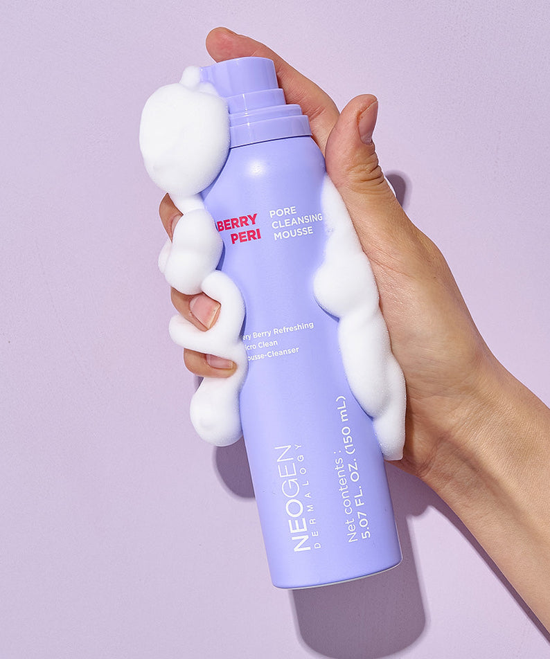 Hand holding NEOGEN Berry Peri Pore Cleansing Mousse 150ml with foam, showcasing the product's texture and packaging.