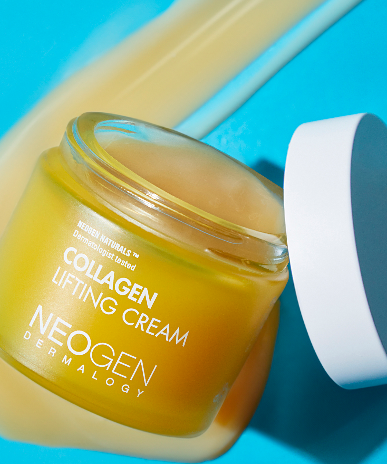 NEOGEN Collagen Lifting Cream 70ml jar with open lid on a blue background
