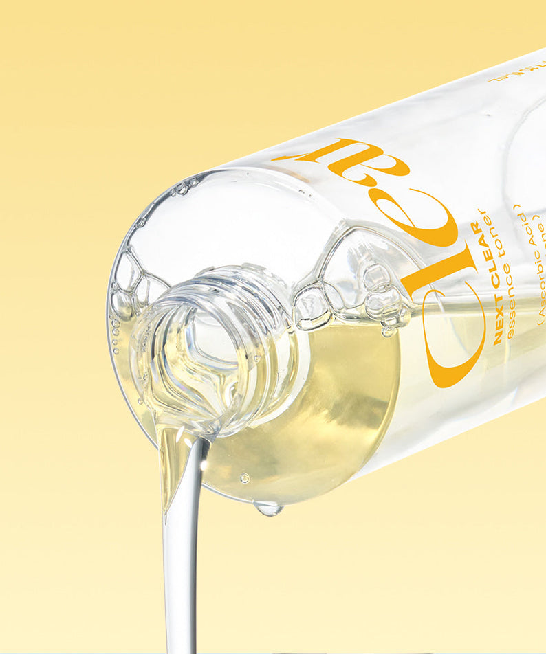 NEOGEN Next Clear Essence Toner 210ml bottle pouring liquid against yellow background