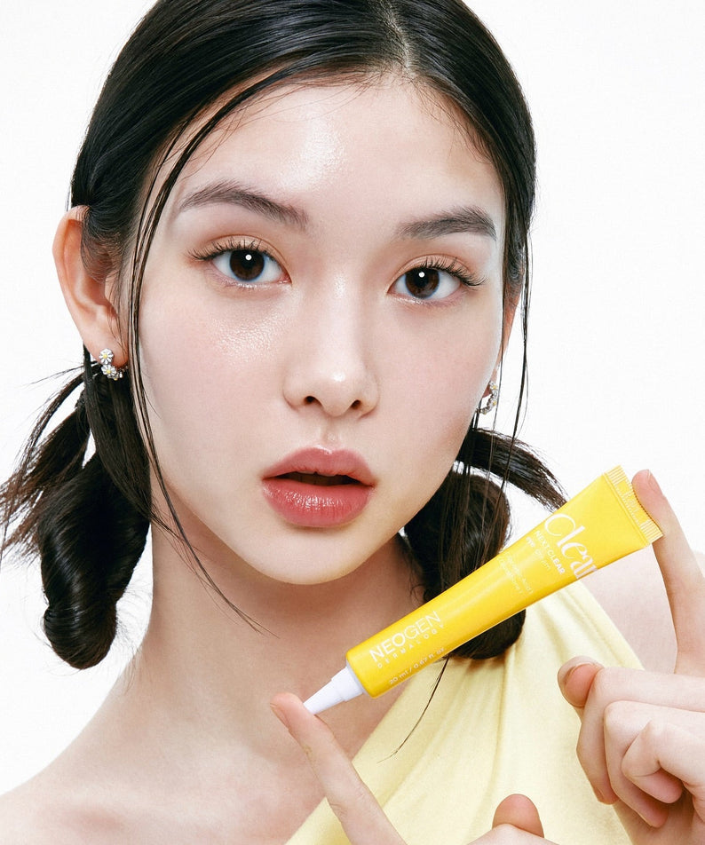 Person holding NEOGEN Next Clear Eye Cream 20ml tube, showcasing skincare product.
