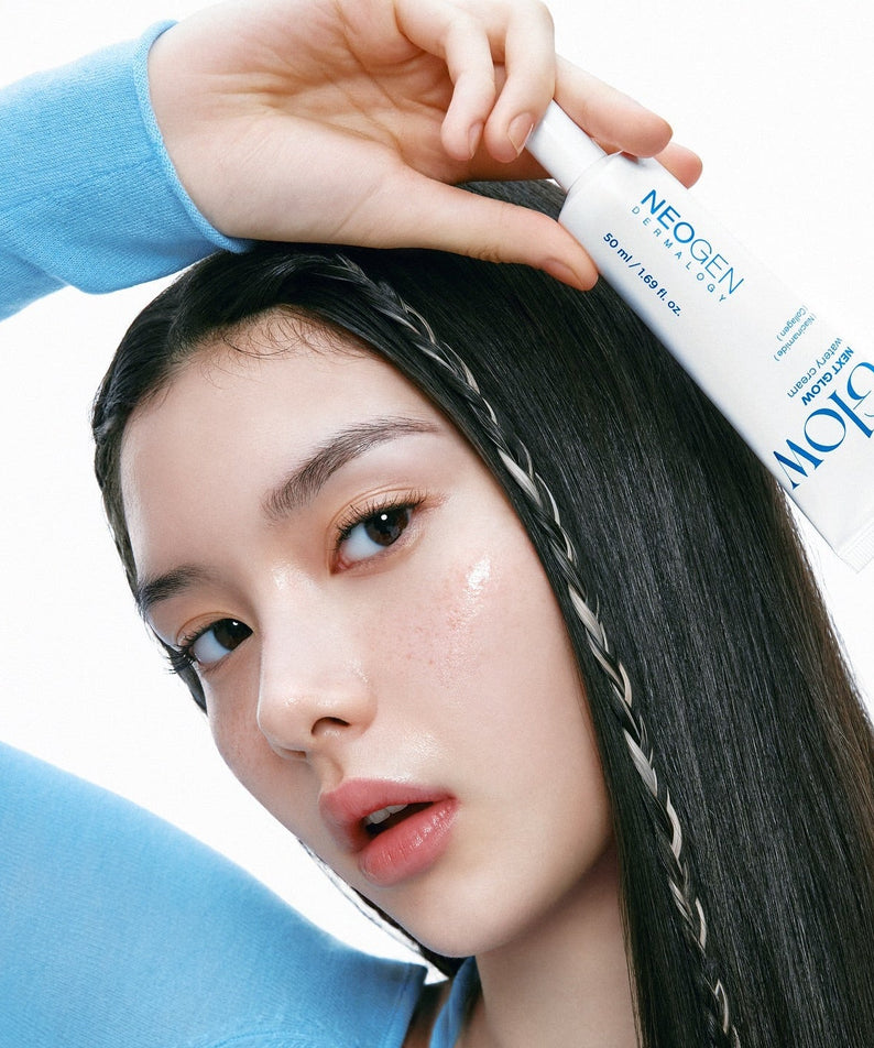 Woman holding NEOGEN Next Glow Moisture Cream 50ml against her face.