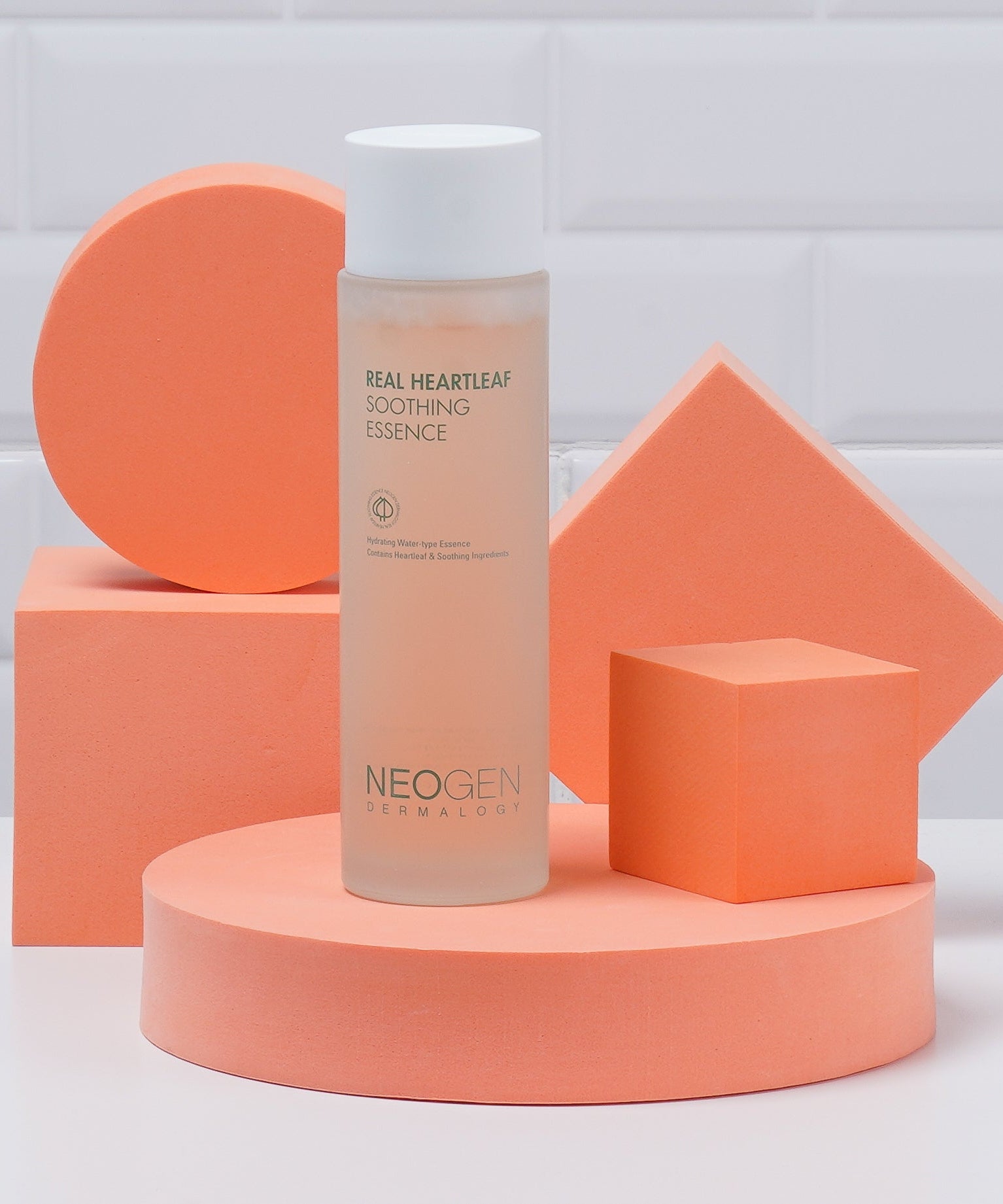 NEOGEN Real Heartleaf Soothing Essence 150ml bottle set against geometric shapes