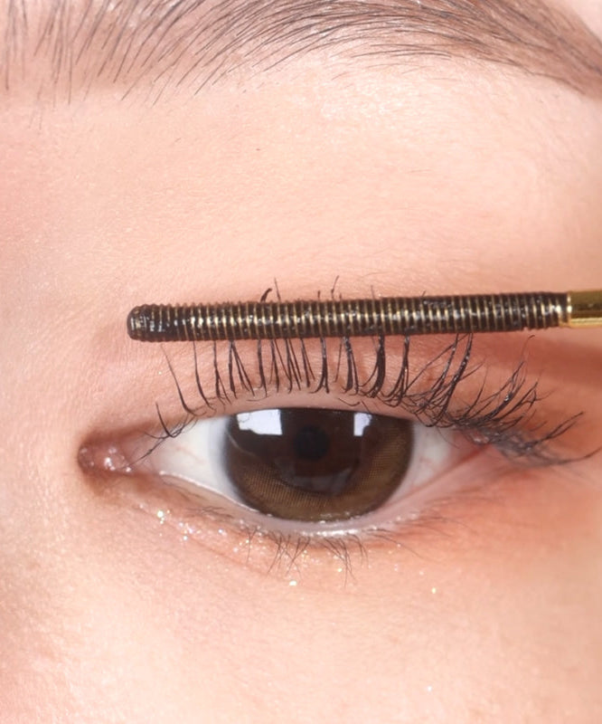 Applying NEOGEN Slim Metal Mascara 6ml for precise eyelash definition