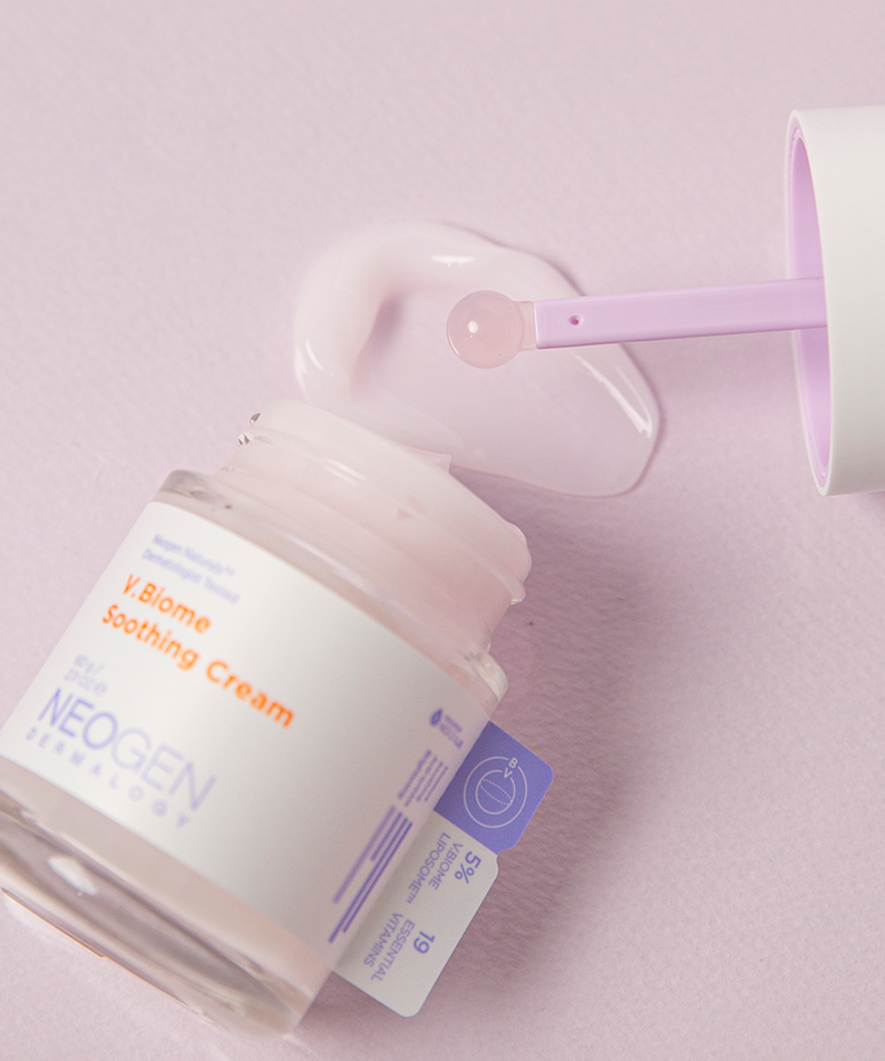 Jar of NEOGEN V Biome Soothing Cream 60g with scoop on pink background.