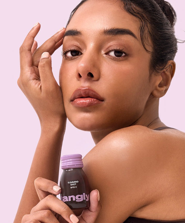 Woman holding NOTHING BETTER Tangly Slimming Shot 7 Bottles close-up, promoting its benefits and effectiveness.