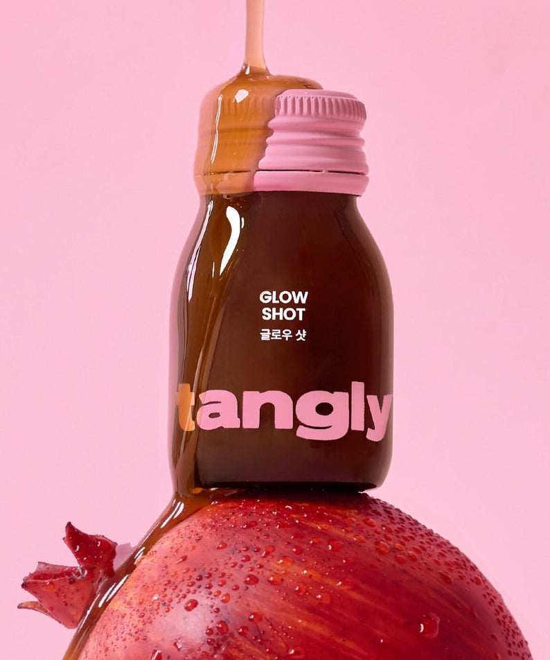 NOTHING BETTER Tangly Glow Shot 7 Bottles featuring a vibrant design with pomegranate on a pink background.